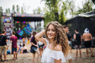 A young woman at summer festival, looking at camera. - HPIF26904