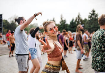 Eine schöne junge Frau tanzt auf einem Sommerfest. - HPIF26920