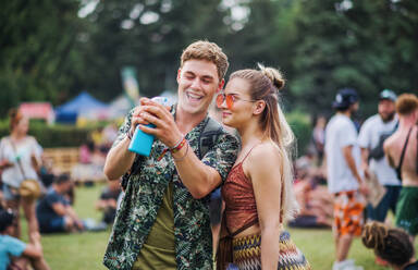 A young couple at summer festival, having fun. - HPIF26930