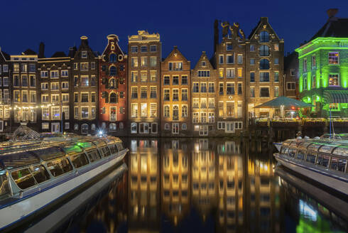 Netherlands, North Holland, Amsterdam, Row of townhouses along canal at night - FCF02137