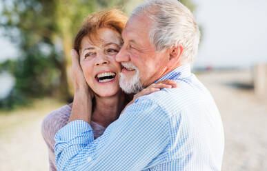 Nahaufnahme eines älteren Paares im Urlaub, das sich beim Spazierengehen umarmt. - HPIF27037