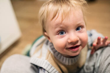 Top view of a cute toddler boy looking up at home. Close up. - HPIF28323