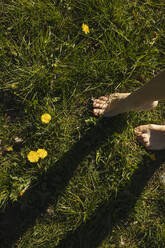 Young woman standing barefoot on grass - VIVF00937