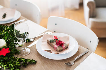 A close-up of a table set for a dinner at home at Christmas time. - HPIF29289