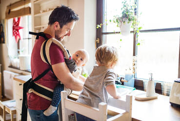 Handsome father and two toddlers washing up the dishes. - HPIF29768