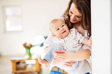 Portrait of an attractive young mother with a baby son at home. Copy space. - HPIF30304