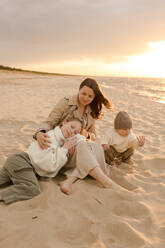 Happy mother with children at beach - VIVF01016