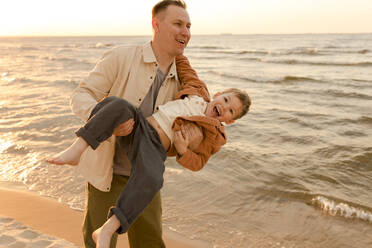 Happy father having fun with son at beach - VIVF01017