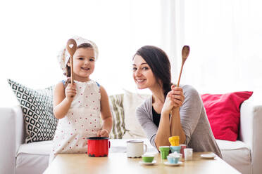 Young mother with a small girl at home, playing. - HPIF30612