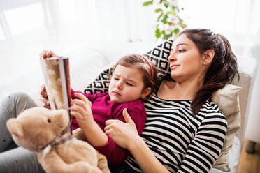 Young mother with a small girl at home, playing. - HPIF30623