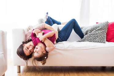 Young mother with a small girl at home, playing. - HPIF30625