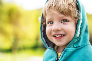 A happy toddler boy outside in spring nature. Close up. Copy space. - HPIF30962