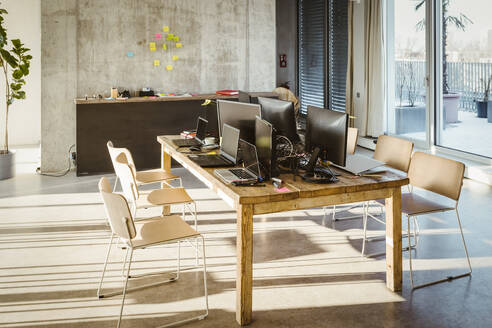 Computers and laptops on desk in creative office - MASF37006