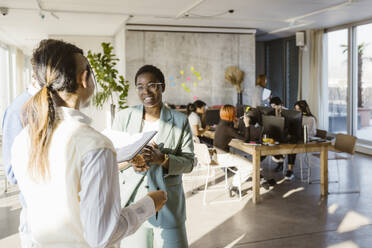 Multiracial colleagues discussing in creative office - MASF37019