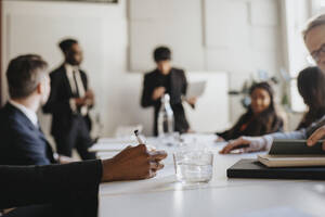 Hand of businesswoman taking down notes during business meeting at office - MASF37132