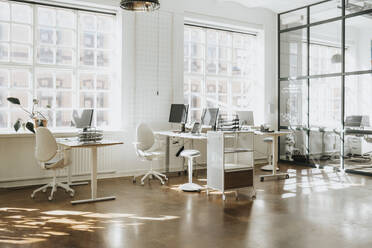 Empty modern workspace with computers arranged on table - MASF37208