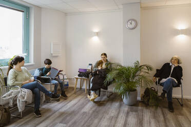 Patients sitting on chair while waiting in clinic - MASF37366