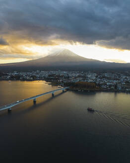 Aerial view of Kawaguchiko bridge in front of Mount Fuji at sunset during koyo season, Lake Kawaguchi, Yamanashi, Japan. - AAEF18230