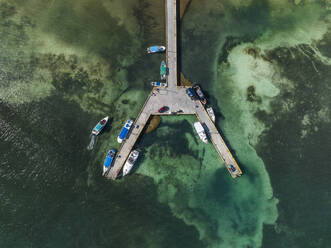 Aerial view of boats moored along a small pier along the coastline, Quintana Roo, Mexico. - AAEF18281