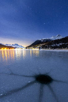 Cracked ice on the frozen surface of Lake Champfer in winter, Silvaplana, Engadine, canton of Graubunden, Switzerland, Europe - RHPLF24180