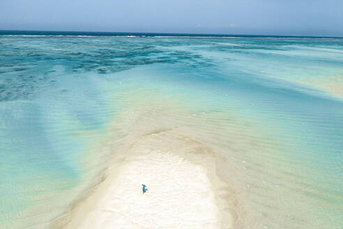 Aerial view of woman walking on sandbank at low tide, Nungwi, Zanzibar, Tanzania, East Africa, Africa - RHPLF24197