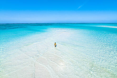 Aerial view of woman bathing in the transparent sea in the scenic sandbanks, Nungwi, Zanzibar, Tanzania, East Africa, Africa - RHPLF24198