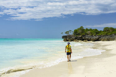 Mid adult man walking on empty sand beach, Nungwi, Zanzibar, Tanzania, East Africa, Africa - RHPLF24199