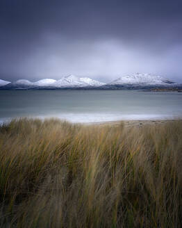 Winter at Luskentyre beach with snow capped mountains, Isle of Harris, Outer Hebrides, Scotland, United Kingdom, Europe - RHPLF24310