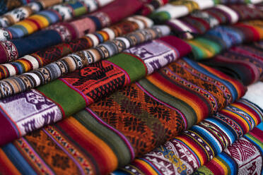 Fabrics at market, Pisaq, Sacred Valley, Cusco, Peru, South America - RHPLF24405