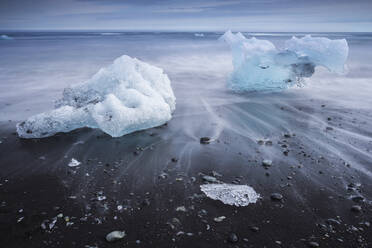 Chunks of ice washed by sea, Diamond beach near Jokulsarlon glacier lagoon, Iceland, Polar Regions - RHPLF24468