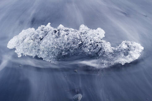 Chunk of ice washed by sea, Diamond beach near Jokulsarlon glacier lagoon, Iceland, Polar Regions - RHPLF24471