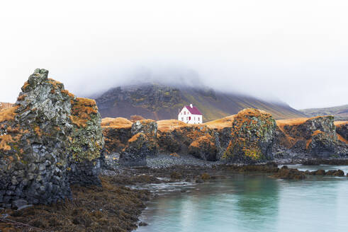 Lonely house above the basalt cliff near the harbour, Arnarstapi, Snaefellsjokull National Park, Snaefellsness peninsula, Vesturland, Western Iceland, Iceland, Polar Regions - RHPLF24499