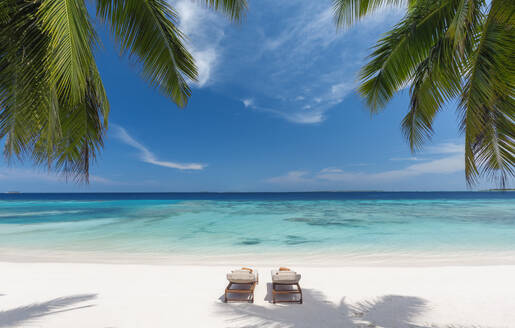 Wooden lounge chairs on a beautiful tropical beach, The Maldives, Indian Ocean, Asia - RHPLF24589