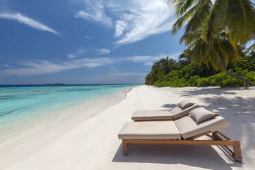 Wooden lounge chairs on a beautiful tropical beach, The Maldives, Indian Ocean, Asia - RHPLF24590