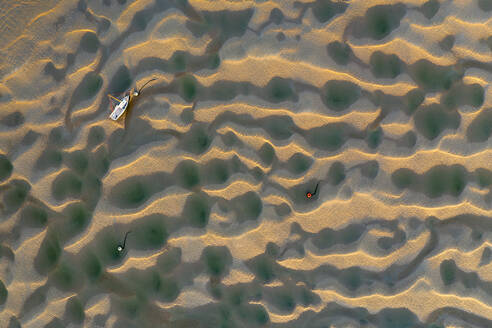 Boat stranded on the Town Bar sandbar in the Camel Estuary at low tide, Rock, Cornwall, England, United Kingdom, Europe - RHPLF24602