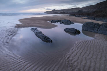 Tidal pools and sand patterns on a deserted Combesgate Beach, North Devon, England, United Kingdom, Europe - RHPLF24612