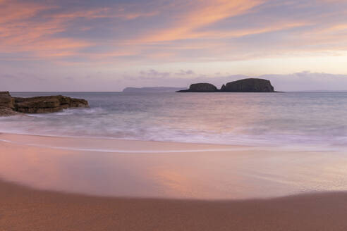 Sunrise over Sheep Island from the sandy shores of Secret Beach at Ballintoy in autumn, County Antrim, Ulster, Northern Ireland, United Kingdom, Europe - RHPLF24624