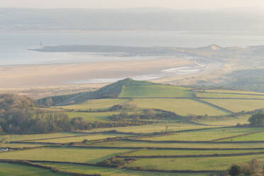 Vista over farmland to Whiteford Sands and Lighthouse in spring, Gower Peninsula, South Wales, United Kingdom, Europe - RHPLF24629