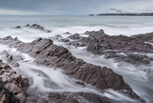 Stormy seas over rocky shores of Downderry Beach, in spring, Cornwall, England, United Kingdom, Europe - RHPLF24646