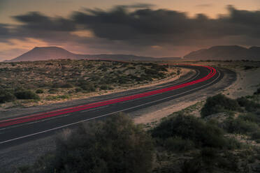 View of trail lights, sand dunes and mountains at dusk, Corralejo Natural Park, Fuerteventura, Canary Islands, Spain, Atlantic, Europe - RHPLF24692