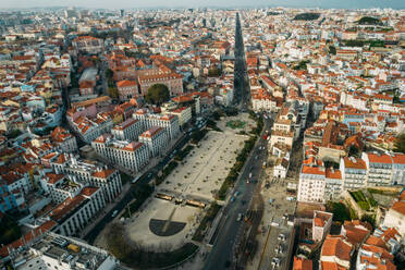Aerial drone view of Martim Moniz Square in Lisbon, with wider view of northern districts of Lisbon in the background, Lisbon, Portugal, Europe - RHPLF24831