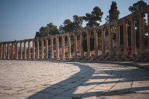 Jerash forum in the early morning with a long colonnade projecting shadows, Jerash, Jordan, Middle East - RHPLF24847