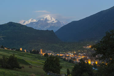 Tetnuldi mountain, 4858 m, rising above Mestia at twilight, Svaneti mountains, Georgia, Central Asia, Asia - RHPLF24928