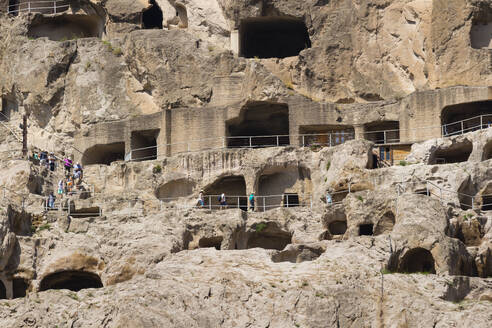 Tourists exploring ancient cave city of Vardzia, Georgia, Central Asia, Asia - RHPLF24956