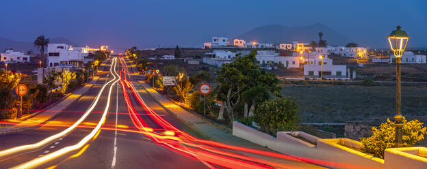 View of trail lights through the town of Tinajo at dusk, Tinajo, Lanzarote, Las Palmas, Canary Islands, Spain, Atlantic, Europe - RHPLF25073