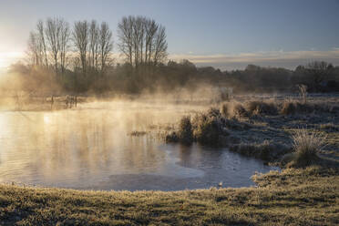 Frosty winter sunrise with mist on the River Test on Chilbolton Cow Common SSSI (Site of Special Scientific Interest), Wherwell, Hampshire, England, United Kingdom, Europe - RHPLF25074