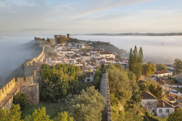 Fog at sunrise over Obidos old town and rampart defensive walls, Obidos, Centro Region, Estremadura, Portugal, Europe - RHPLF25082