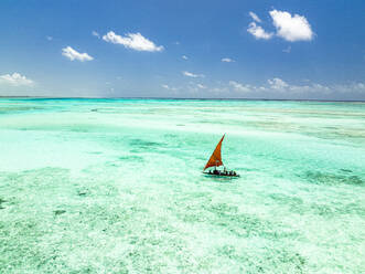 Tourists enjoying a boat trip on traditional dhow in the crystal sea, Paje, Jambiani, Zanzibar, Tanzania, East Africa, Africa - RHPLF25118