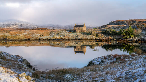 Abandoned house reflected in the loch on a winter's day, Isle of Harris, Outer Hebrides, Scotland, United Kingdom, Europe - RHPLF25213