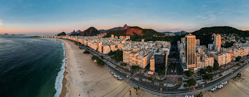 Aerial drone view of Copacabana Beach and urban setting at sunrise, UNESCO World Heritage Site, Rio de Janeiro, Brazil, South America - RHPLF25251